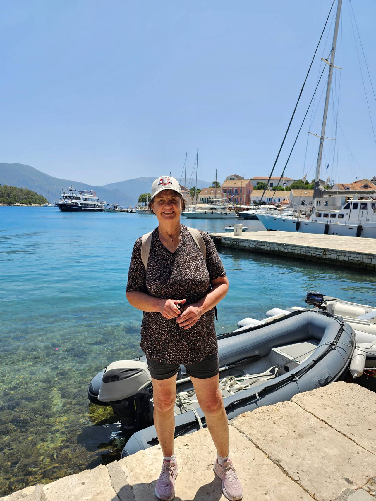 A person standing on a dock near water

Description automatically generated