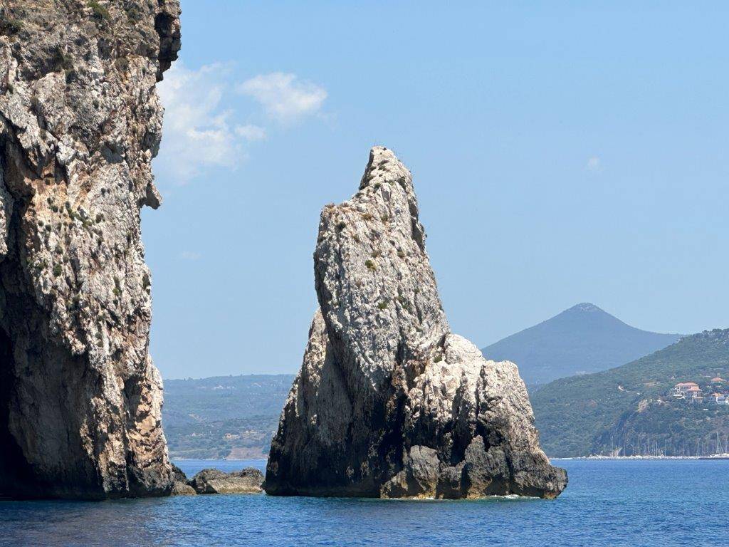 A large rock formation in the water

Description automatically generated
