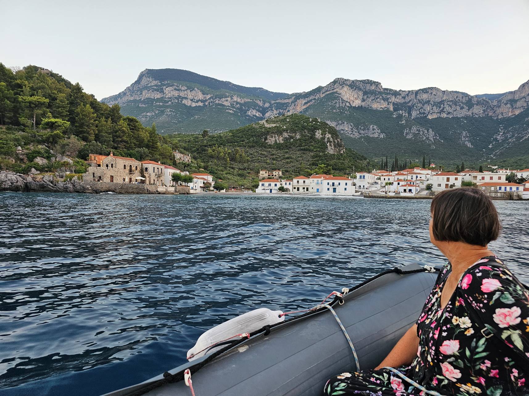 A person sitting in a boat on the water

Description automatically generated