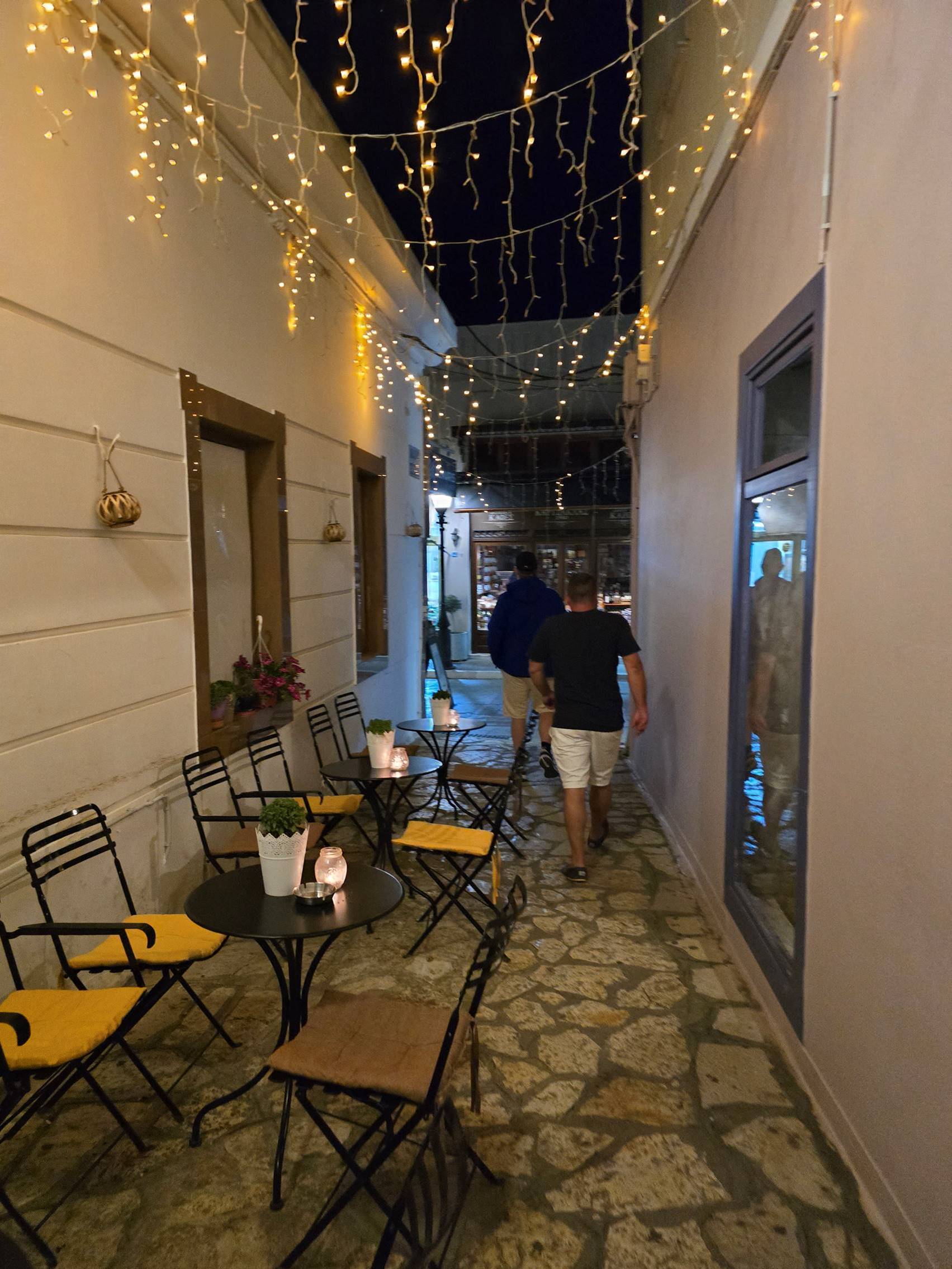 A person standing in a courtyard

Description automatically generated