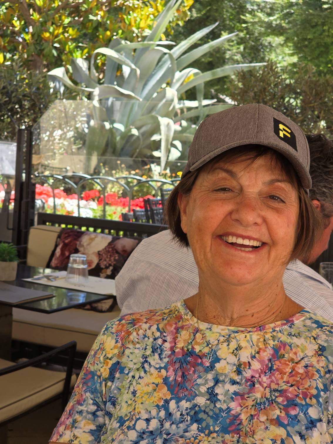A person smiling at the camera

Description automatically generated