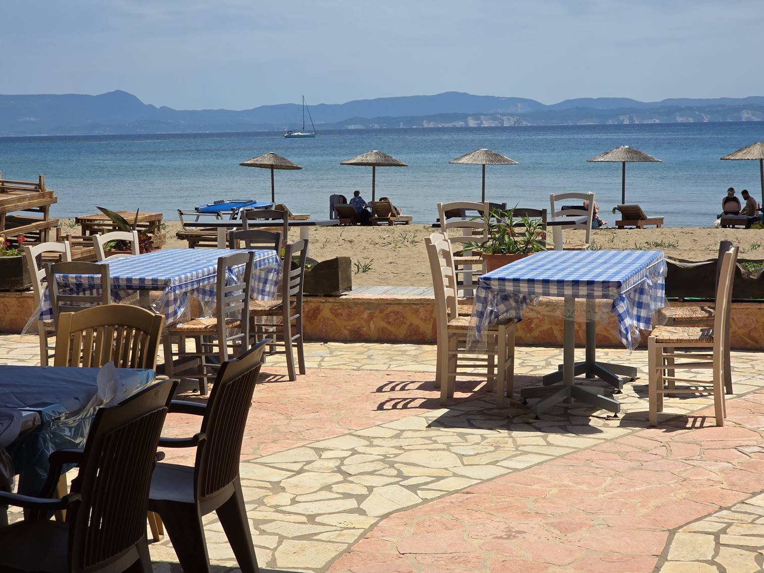 Tables and chairs on a beach

Description automatically generated