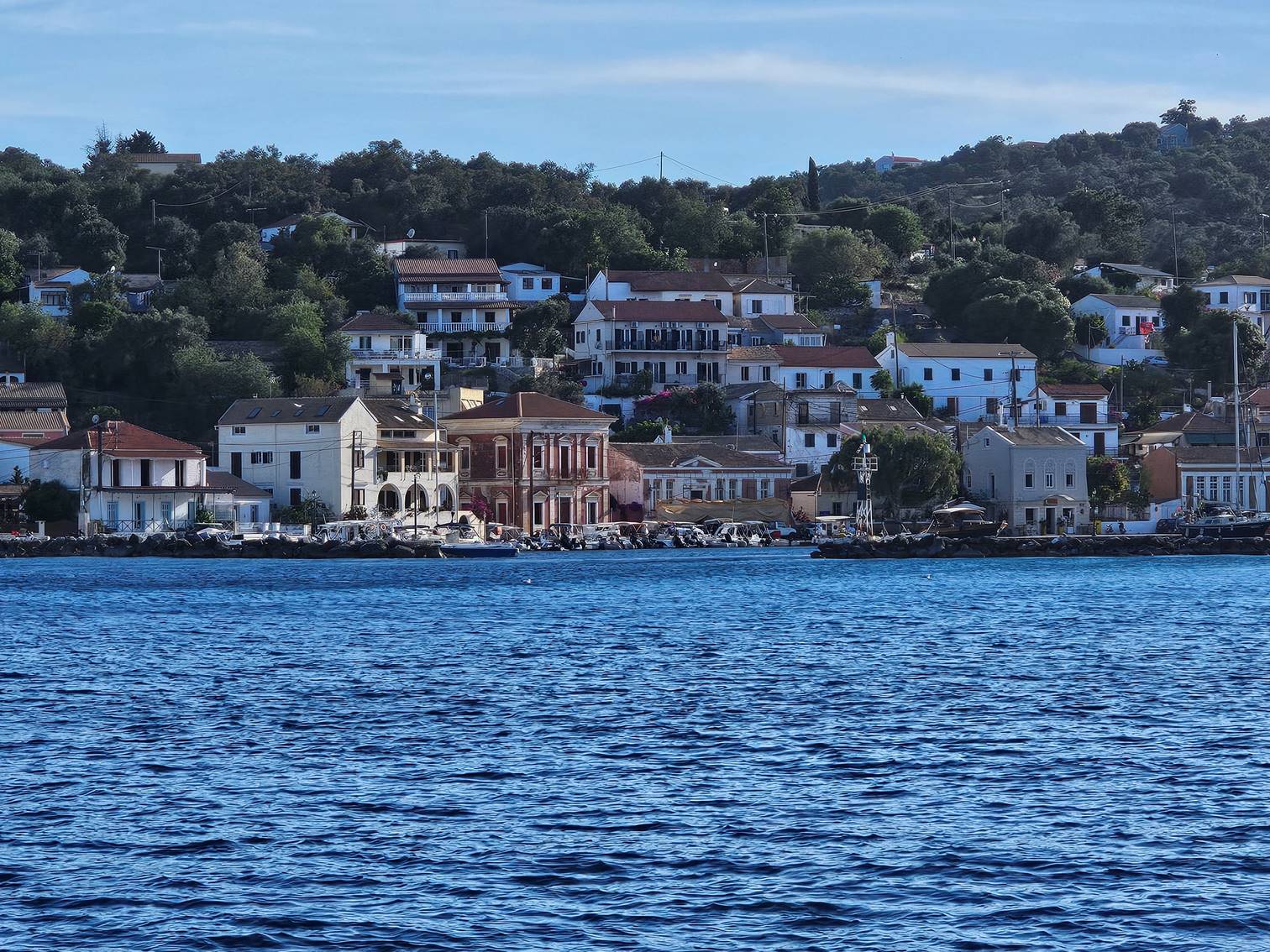 A body of water with buildings and trees

Description automatically generated
