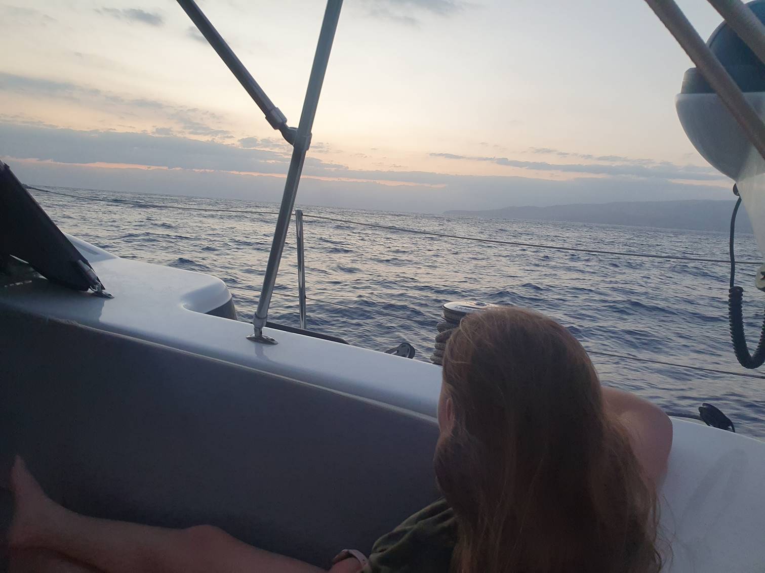 A person on a boat looking out the water

Description automatically generated