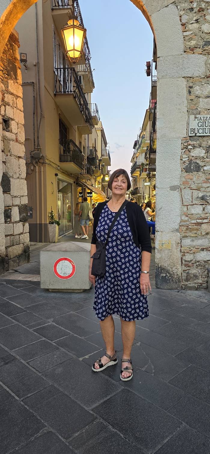 A person standing on a stone block

Description automatically generated